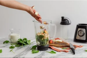 Modern kitchen making fresh fruit smoothie