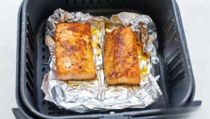 User placing aluminum foil sheet correctly in air fryer