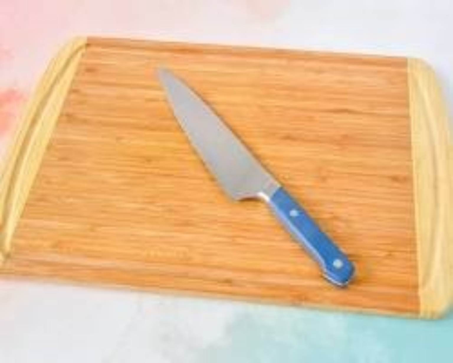 Chef’s knife and cutting board used for meal preparation