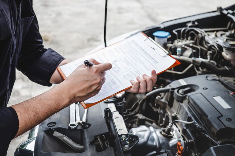 Mechanic performing routine vehicle check applying essential car maintenance tips