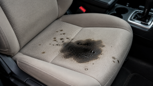 Oil stain on car seat upholstery

