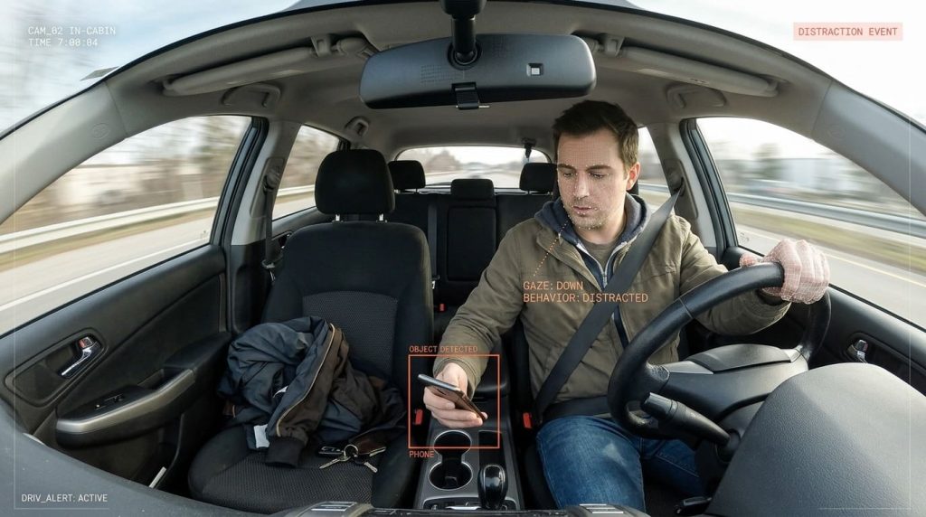 AI dashcam detecting distracted driver using a smartphone while driving, highlighting gaze direction and phone detection alert.