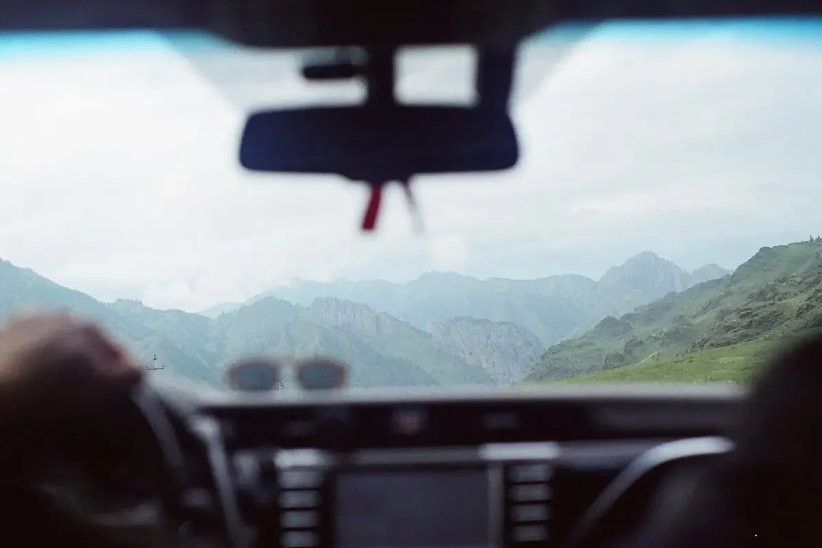 Scenic view of a road through a car windshield, capturing the drive ahead.